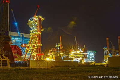 Illuminated built structure against sky at night