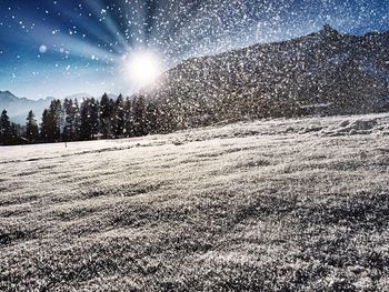 Scenic view of snow covered field against sky