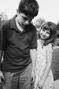 Portrait of siblings standing outdoors