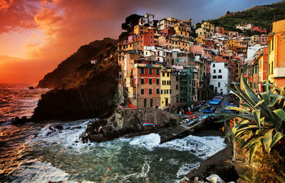 Buildings in city at sunset