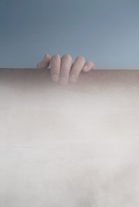 Close-up of person hand on wood board in fog