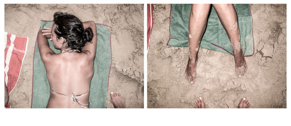 Personal perspective of person photographing woman sunbathing on beach