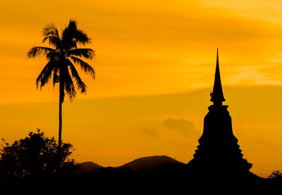 Silhouette of palm tree against sky during sunset