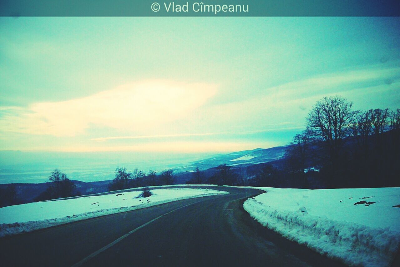 sky, road, the way forward, snow, winter, transportation, cloud - sky, blue, cold temperature, tranquil scene, diminishing perspective, tranquility, nature, street, scenics, cloud, weather, tree, beauty in nature, empty road