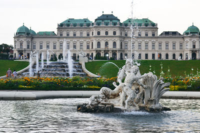 Statue of fountain in front of building