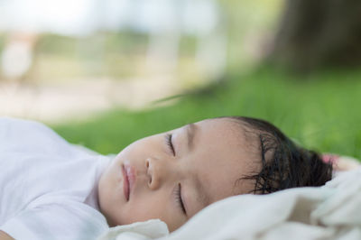 Portrait of woman sleeping on bed