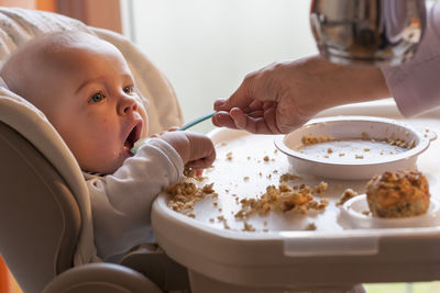 High angle view of baby eating food on table