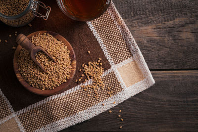 Bowl of fenugreek seeds and egyptian fenugreek yellow tea or methi dana drink