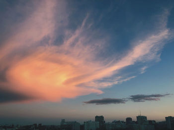 Buildings in city against sky during sunset