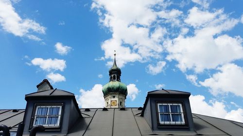 Low angle view of building against cloudy sky