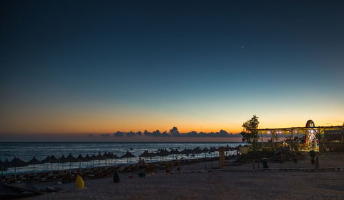 Scenic view of sea against clear sky at sunset