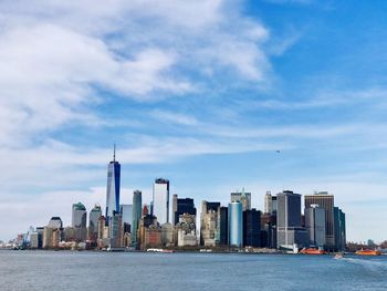 Sea with skyscrapers in background