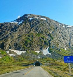 Road amidst mountains against clear sky