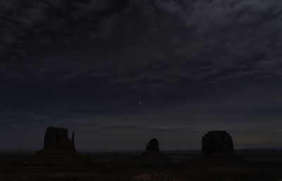 Scenic view of rock formation against sky at night