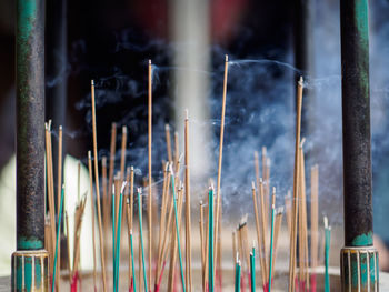 Close-up of burning incenses in temple