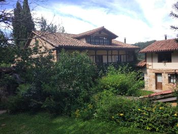 House by trees against sky