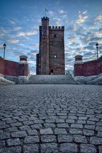 View of old building against cloudy sky