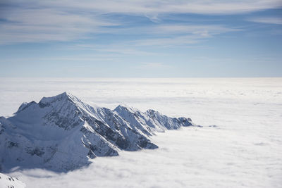 Scenic view of snowcapped mountains and cloudscape