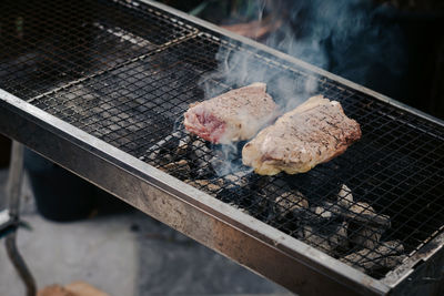 High angle view of meat on barbecue grill