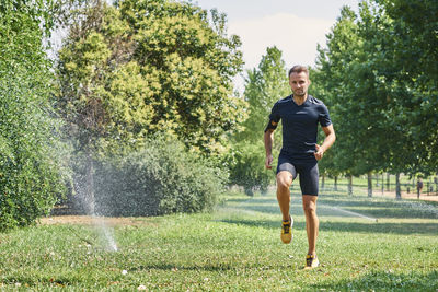 Young man training in a park, he is jogging.