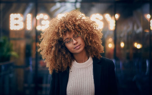 Portrait of smiling young woman at night