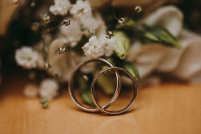 Close-up of wedding rings on table