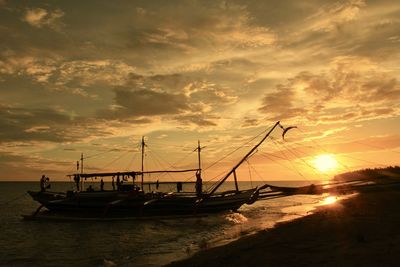 Scenic view of sea against dramatic sky during sunset