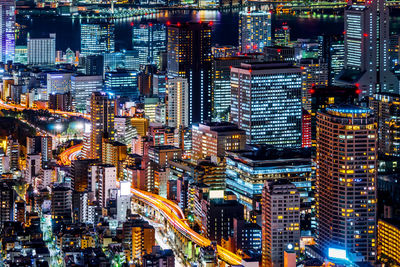 Aerial view of illuminated buildings in city at night