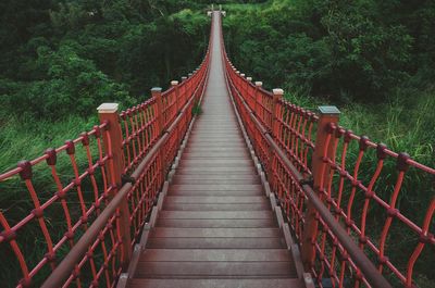 Footbridge leading towards trees