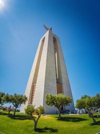 Low angle view of built structure against clear blue sky during sunny day