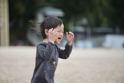 Girl crying while running outdoors