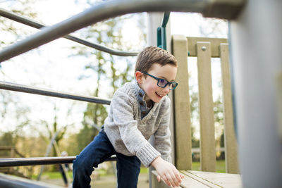 Young boy climbing on playground equipment. on the move