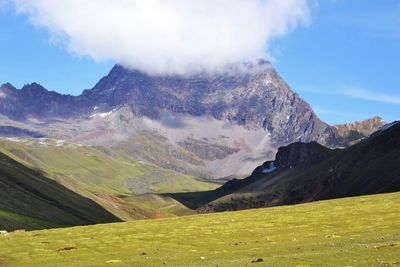 Scenic view of mountains against cloudy sky