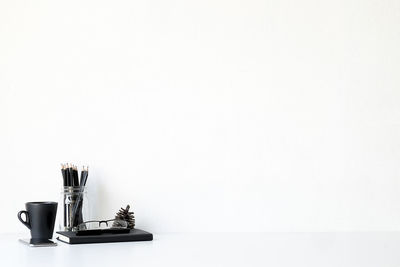 High angle view of cigarette on table against white background