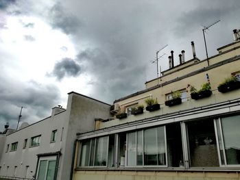 Low angle view of building against cloudy sky