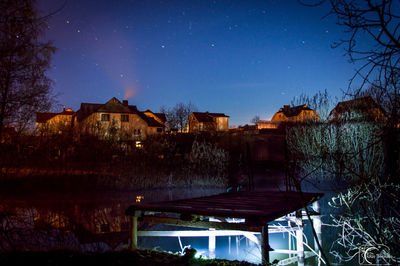 Built structures against clear sky at night