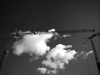 Low angle view of crane against sky