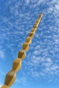 Low angle view of smoke stack against blue sky