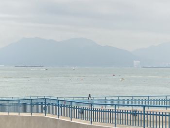 Scenic view of sea and mountains against sky