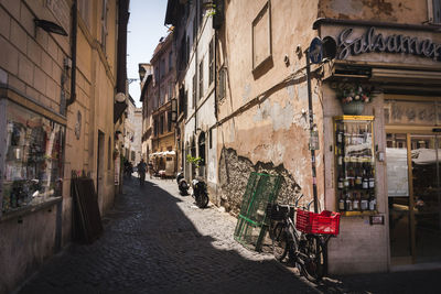 Narrow street amidst buildings in city