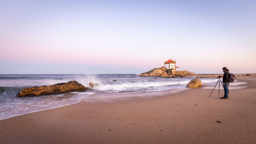 Scenic view of sea against clear sky during sunset