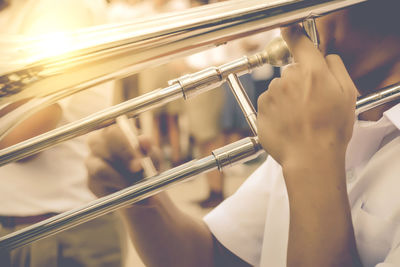 Midsection of man playing musical equipment