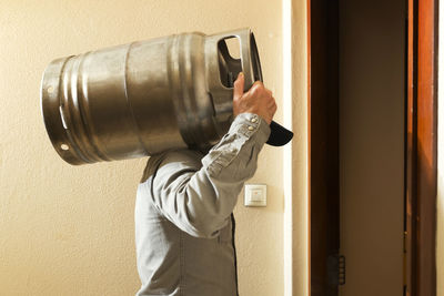 Man carrying gas cylinder at home