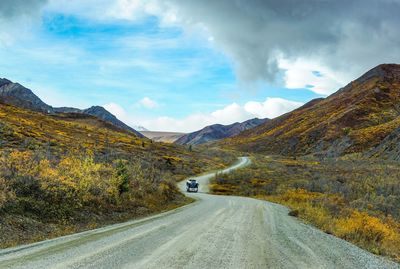 Road amidst mountains against sky