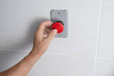 Cropped hand of man holding telephone