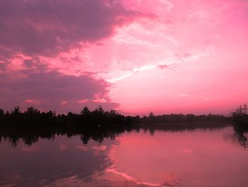 Scenic view of lake against romantic sky at sunset