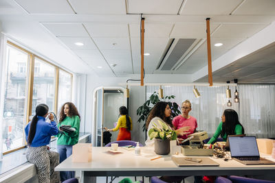 Multiracial female colleagues working together at modern office