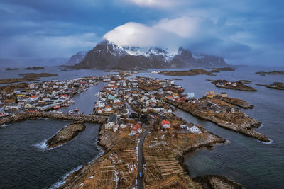 High angle view of city by sea against sky