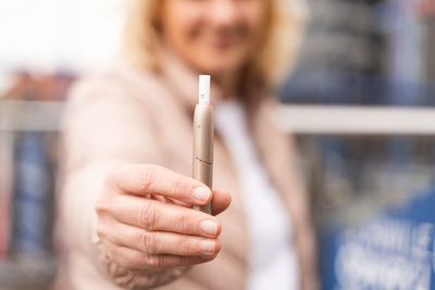 Cropped hand of woman using mobile phone