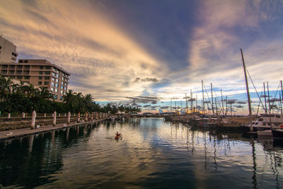 Yachts moored in marina against romantic sky